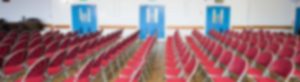Rows of chairs and doors in the school hall